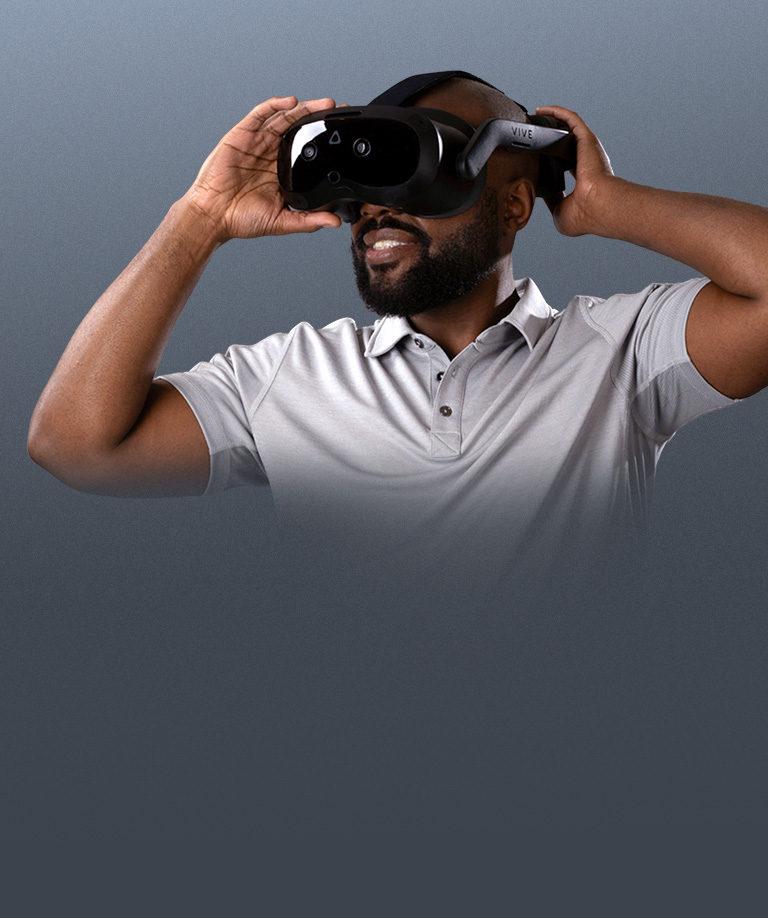 Man wearing and adjusting the VIVE Focus Vision headset for a secure fit
